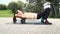 Beautiful well-trained woman is doing exercises with the fascia roll