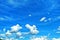 Beautiful whimsical clouds against the blue daytime sky.