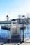 Beautiful white alcove in the park. View of the bridge leading to the alcove on the lake