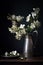 beautiful white apple blossom flowers in a vintage pewter jug. Dark and moody still life