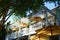 Beautiful white balcony of restaurant with yellow outdoor umbrella and bamboo under sun light, architecture concept