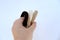 Beautiful white, beige and brown elastic hairband, scrunchie on female hand on a white background close-up, the concept of women`