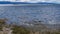 Beautiful white and black ducks swim in the blue lake. Ripples on the water.