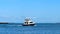 Beautiful white and black fishing yacht boat on the blue water
