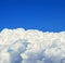 Beautiful white clouds beneath blue sky background