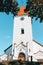 Beautiful white Evangelical Lutheran Church of Talsi in Latvia with orange tile rooftop during sunny summer day