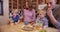 Beautiful white family eating cookies and milk together