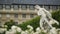 Beautiful white flowers, ancient statue and Luxembourg Palace in Paris, France