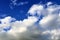 Beautiful white fluffy cloud formations on a blue sky taken in spring