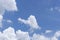 Beautiful white fluffy clouds on vivid blue sky in a sunny day upward photo and copy space