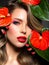 Beautiful white girl with red  flowers. Stunning girl with  Anthurium red. Closeup face of young beautiful blonde woman with a