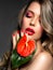 Beautiful white girl with red  flowers. Stunning girl with  Anthurium red. Closeup face of young beautiful blonde woman with a