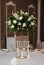 Beautiful White and Green Flower Decoration Arrangement on Wedding Table Golden Support . Wedding Bridal Flower Decoration.