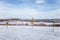 A beautiful white landscape of a snowy winter day with tracks for snowmobile or dog sled