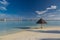 Beautiful white Maldivian beach with parasol and turquoise sea