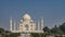 Beautiful white marble ancient Taj Mahal against the blue sky.