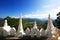 Beautiful White Pagoda and lion sculpture with blue sky Located along the cliff on the mountain in Phra That Doi Kong Mu Temple at