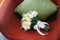 Beautiful white roses with ribbon on red armchair with pillow. Wedding concept. Flowers. Celebration concept. Brides bouquet