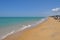 Beautiful white sand beach and ocean waves with clear blue sky