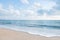 Beautiful white sand beach and ocean waves with clear blue sky