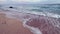 Beautiful white sand tropical beach at ocean shore. Background with twilight above sea waves splashing on shore with