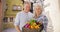 Beautiful white senior couple carrying hand picked vegetables