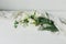 Beautiful white tulips and daffodils on soft fabric on rustic wooden table. Happy Mothers day. Stylish simple spring bouquet,