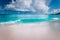 Beautiful white wave rolling towards tropical sandy beach. Gorgeous fluffy clouds above blue sea. Seychelles Grand Anse