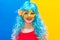 Beautiful white woman dressed for a Carnival night. A smiling girl in a blue wig and yellow mask is going to celebrate a