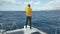 Beautiful white yacht breaks the waves. Man stands on the bow of the yacht. Clear blue water around Canary islands in