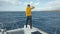 Beautiful white yacht breaks the waves. Man stands on the bow of the yacht. Clear blue water around Canary islands in