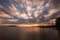 Beautiful wide angle, long exposure view of a lake at sunset, with an huge sky with moving clouds