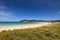 Beautiful wide angle view of Matapouri Beach near Whangarei on the North Island of New Zealand. Grass in the foreground