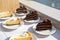 beautiful wide capture of chocolate and white chocolate cake and pie desserts during a wedding on a bright sunny day at a venue