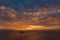 Beautiful wide twilight sunset evening sky reflect on sea water with silhouette boat in ocean and epic cloud pattern background