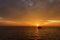 Beautiful wide twilight sunset evening sky reflect on sea water with silhouette boat in ocean and epic cloud pattern background