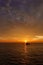 Beautiful wide twilight sunset evening sky reflect on sea water with silhouette boat in ocean and epic cloud pattern background