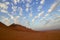 Beautiful wide view of desert sand dunes in Mleiha Fossil Rock in Sharjah, United Arab Emirates.