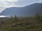 Beautiful wild Lapland nature landscape with STF Kaitumjaure Mountain cabin hut, lake, birch tree forest and mountains. Northern S