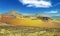 Beautiful wild rough surreal volcanic landscape, red yellow volcano crater, lava ash field, clear blue sky - Timanfaya NP,