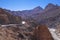 Beautiful winding road through mountain range in summer against clear sky