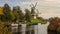 The beautiful windmills of Greetsiel with ships in the canal in the sunshine.