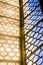 Beautiful window with forged round pattern in the german catholic church. Light and shadow