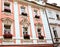 Beautiful windows with flowerpots and flowers. Decorative elements on ancient facade buildings. Architecture  on the streets of