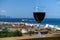 Beautiful wineglass with red wine, standing on the open deck against the backdrop of sea waves. Side view, close-up. Concept of