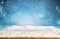 Beautiful winter background with wooden old desk and blurred blue sky. Winter, New Year and Christmas concept with snowy