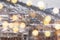 Beautiful winter blurred background of Tbilisi city with falling snow and bokeh lights