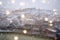 Beautiful winter blurred background of Tbilisi city with falling snow and bokeh lights