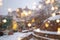 Beautiful winter blurred background of Tbilisi city with falling snow and bokeh lights