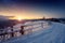 Beautiful winter fairytale landscape, stars and rising sun over the snowy mountain road